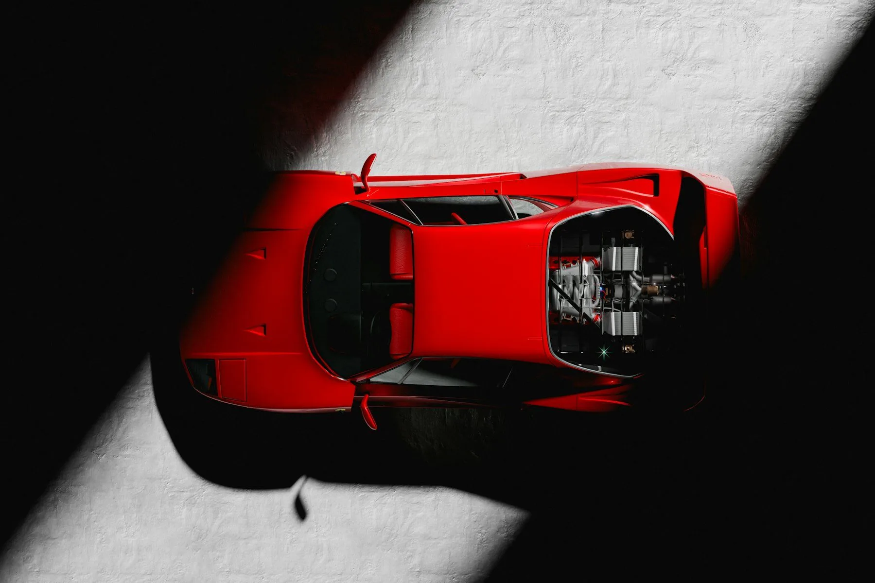 Red Ferrari F40 seen from above in a shaft of light